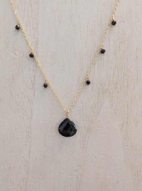 Gold necklace with a black onyx briolette and satellite beads